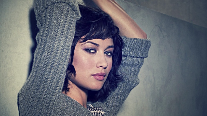 Olga Kurylenko wearing a gray sweater