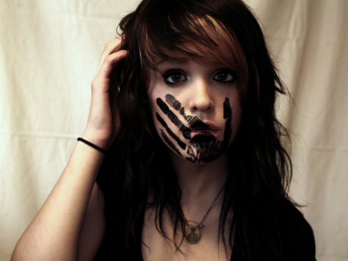 Woman with handprint on face