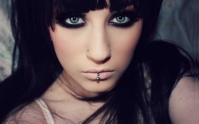Woman with dark hair and heavy eye makeup