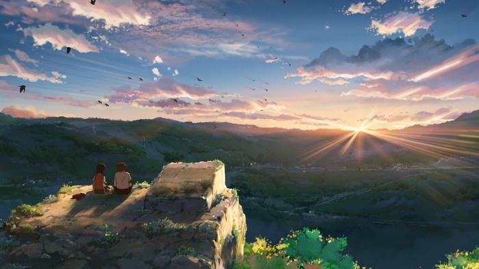 Children watching the sunset over a valley