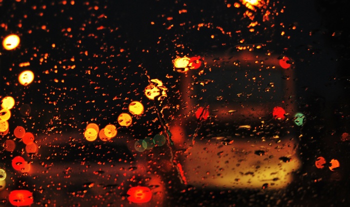 Bokeh lights on wet glass at night