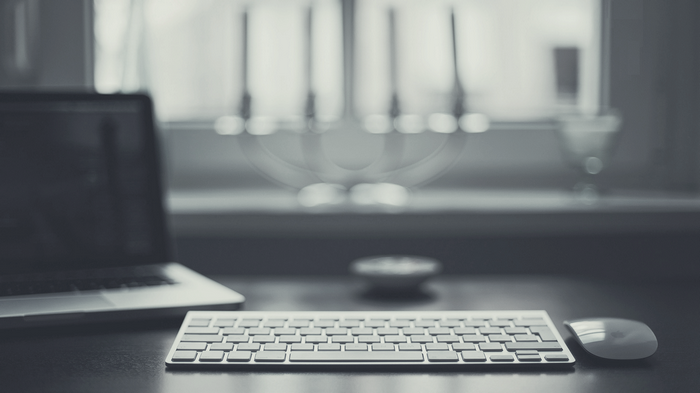 Apple laptop, keyboard, and mouse on a desk