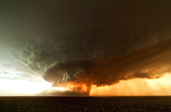 A massive tornado storm over a field