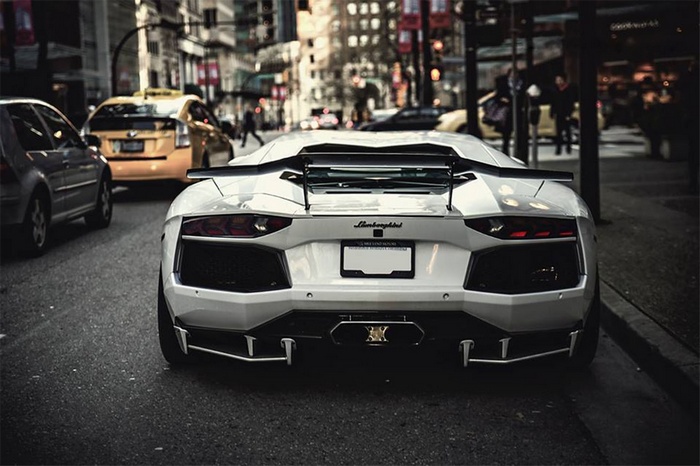 White Lamborghini Aventador parked on a city street