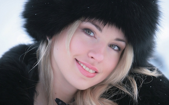 Woman in a black fur hat outdoors