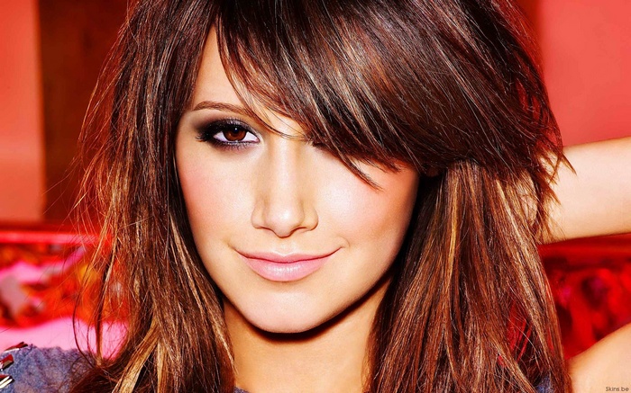 Ashley Tisdale smiling with long brown hair