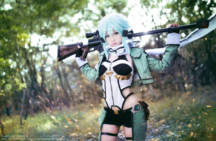 Asada Shino cosplay with a sniper rifle in a forest