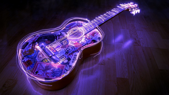 Guitar with purple neon light outline and stickers