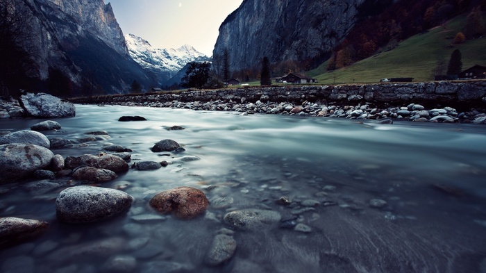 River flowing through a mountain valley with snow-capped peaks