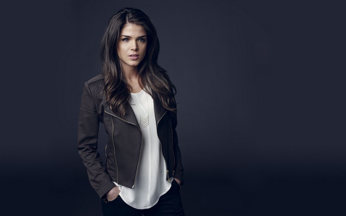 Marie Avgeropoulos wearing a jacket and white top