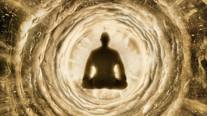 Man meditating in a glowing tunnel
