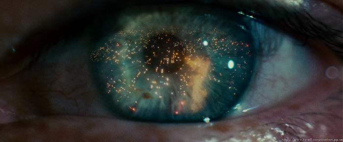 Close-up of an eye reflecting a futuristic city