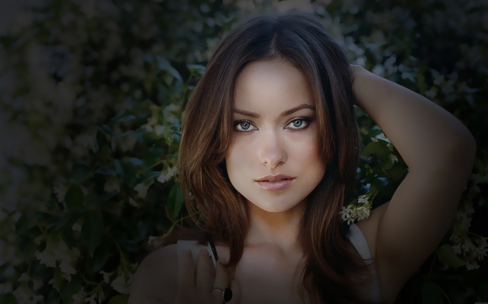 Olivia Wilde with her hand on her head