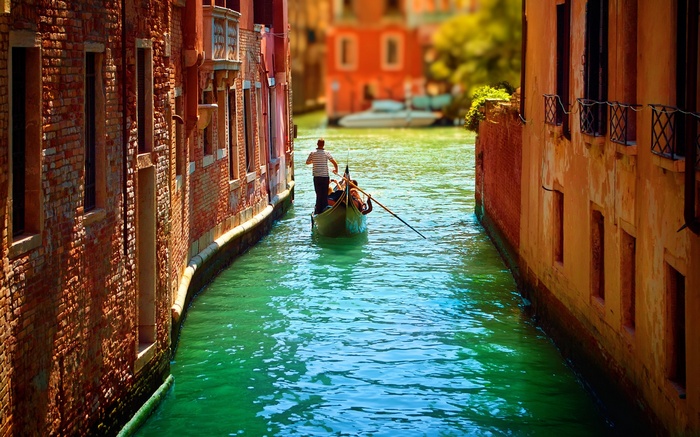 Gondola ride through a canal in Venice, Italy