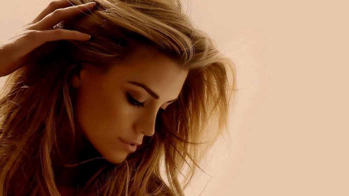 Blonde woman with hand in hair