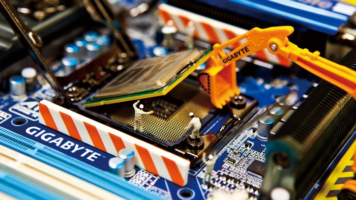 Gigabyte motherboard with CPU and miniature construction workers