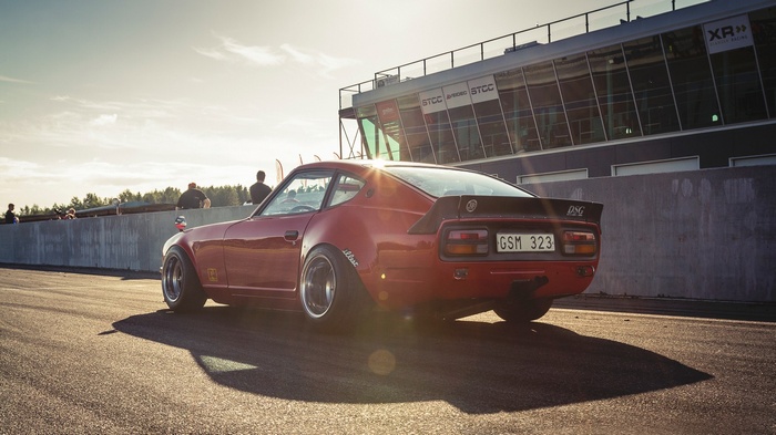 Red Datsun 240Z on a race track