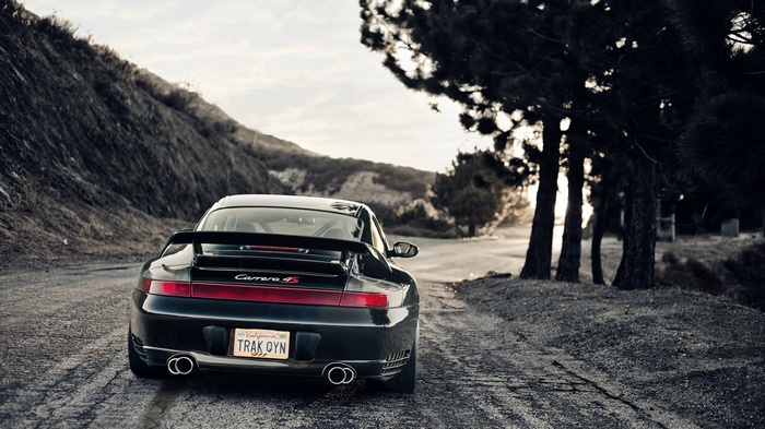 Black Porsche Carrera S on a dirt road