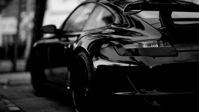 Black Porsche sports car with a spoiler