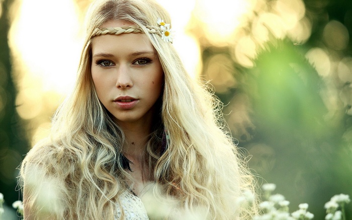 Blonde woman with braided headband and flowers