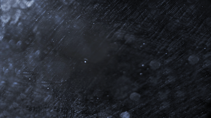 Dark background with water droplets and streaks