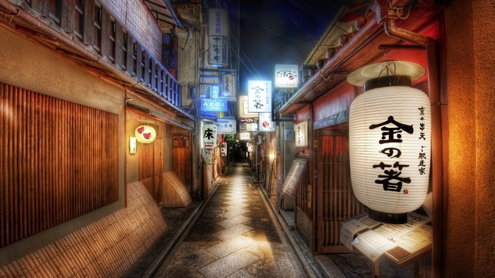 Japanese street at night with lanterns and signs