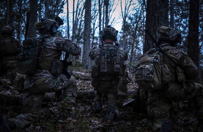 Soldiers in tactical gear in a forest