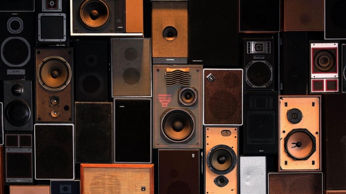 A wall of vintage speakers of various sizes and colors