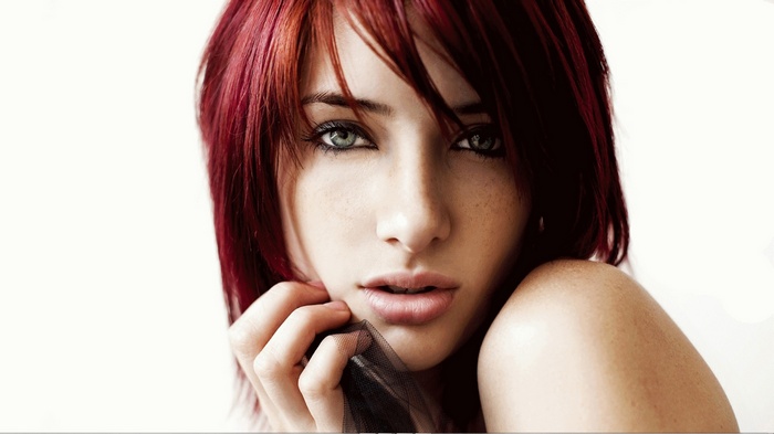 Susan Coffey portrait with red hair and bare shoulders