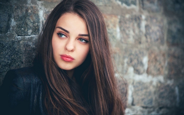 Woman with long brown hair and blue eyes