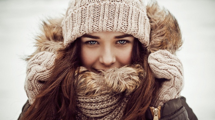 Woman in knit hat and scarf outdoors in winter