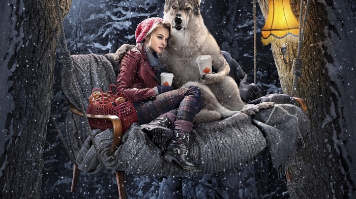 Girl and wolf sitting on a bench in the snow