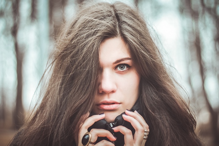 Woman with long dark hair and rings