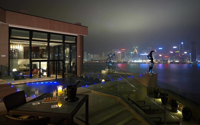 Night cityscape view from a modern house balcony