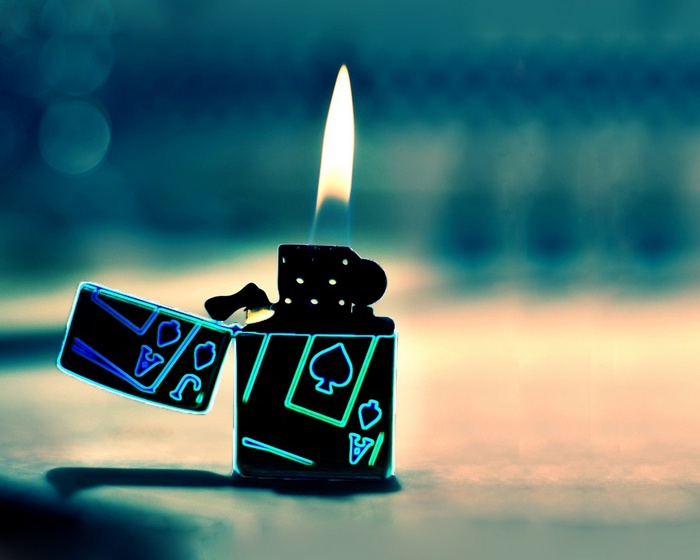 Lighter with playing card designs and flame