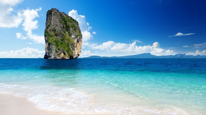 Rock formation in the ocean near a beach in Thailand