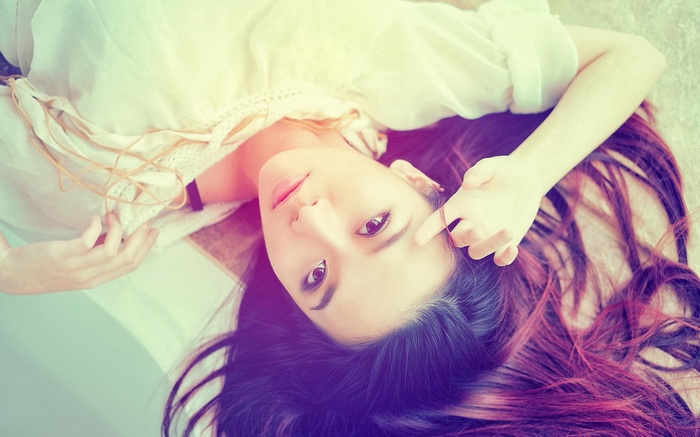 Asian woman lying down with her hair spread out