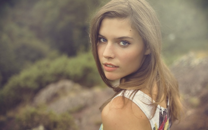 Woman with blue eyes and blonde hair outdoors