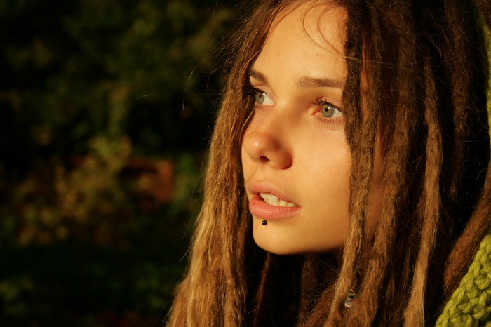 Woman with dreadlocks and lip piercing outdoors