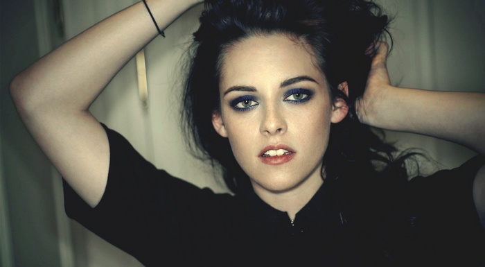 Kristen Stewart with dark hair and blue eyeshadow