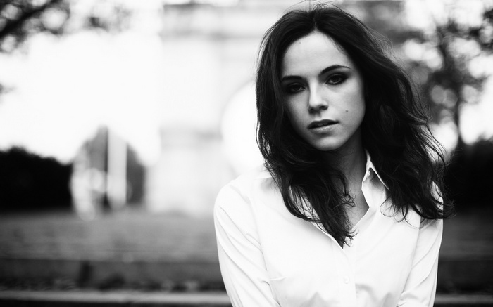 Monochrome portrait of a brunette woman in a white top