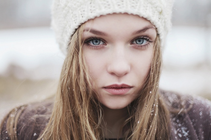 Woman with blue eyes and blonde hair in winter