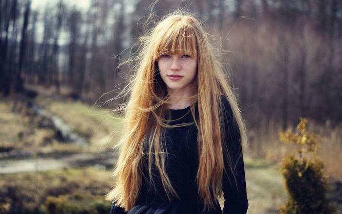 Young woman with long blonde hair outdoors