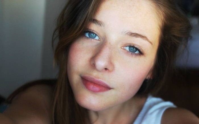 Young woman with blue eyes and freckles