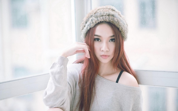 Asian woman with long hair wearing a fur hat