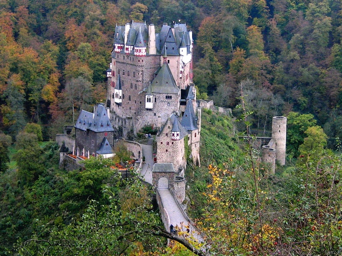 Eltz Castle in a forest during autumn
