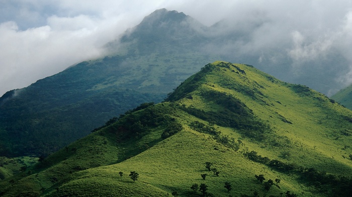 Misty mountains and green hills landscape
