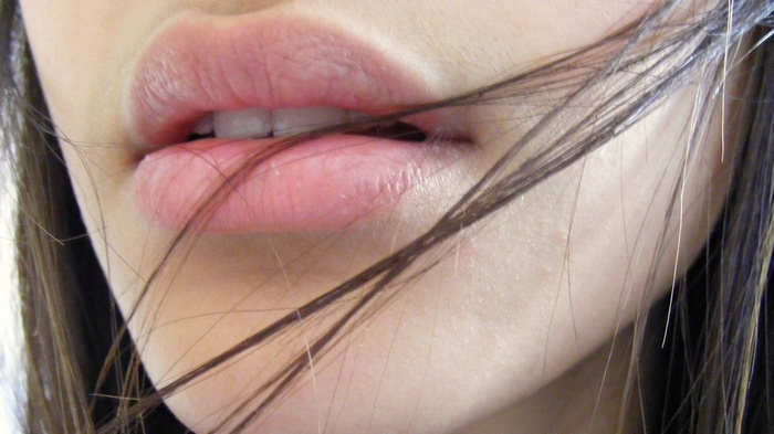 Close-up of a woman's lips with hair