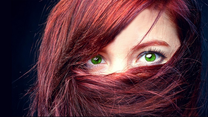 Woman with red hair and green eyes