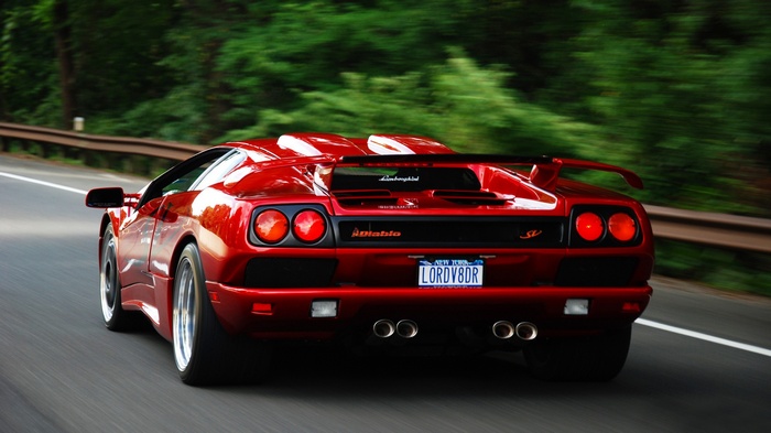 Red Lamborghini Diablo SV driving on a road